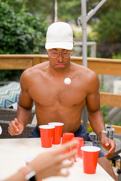 Cup pong game with red cups and ping pong ball