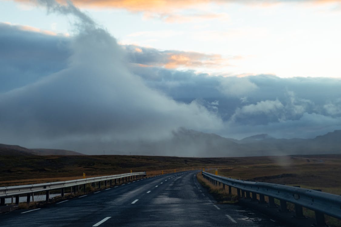 Asphalt Road Under White Clouds