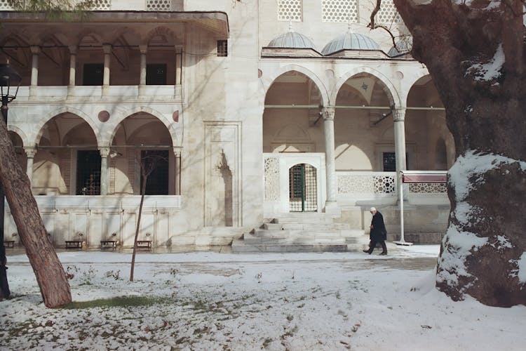 Man Walking Past Empty Monumental Building 