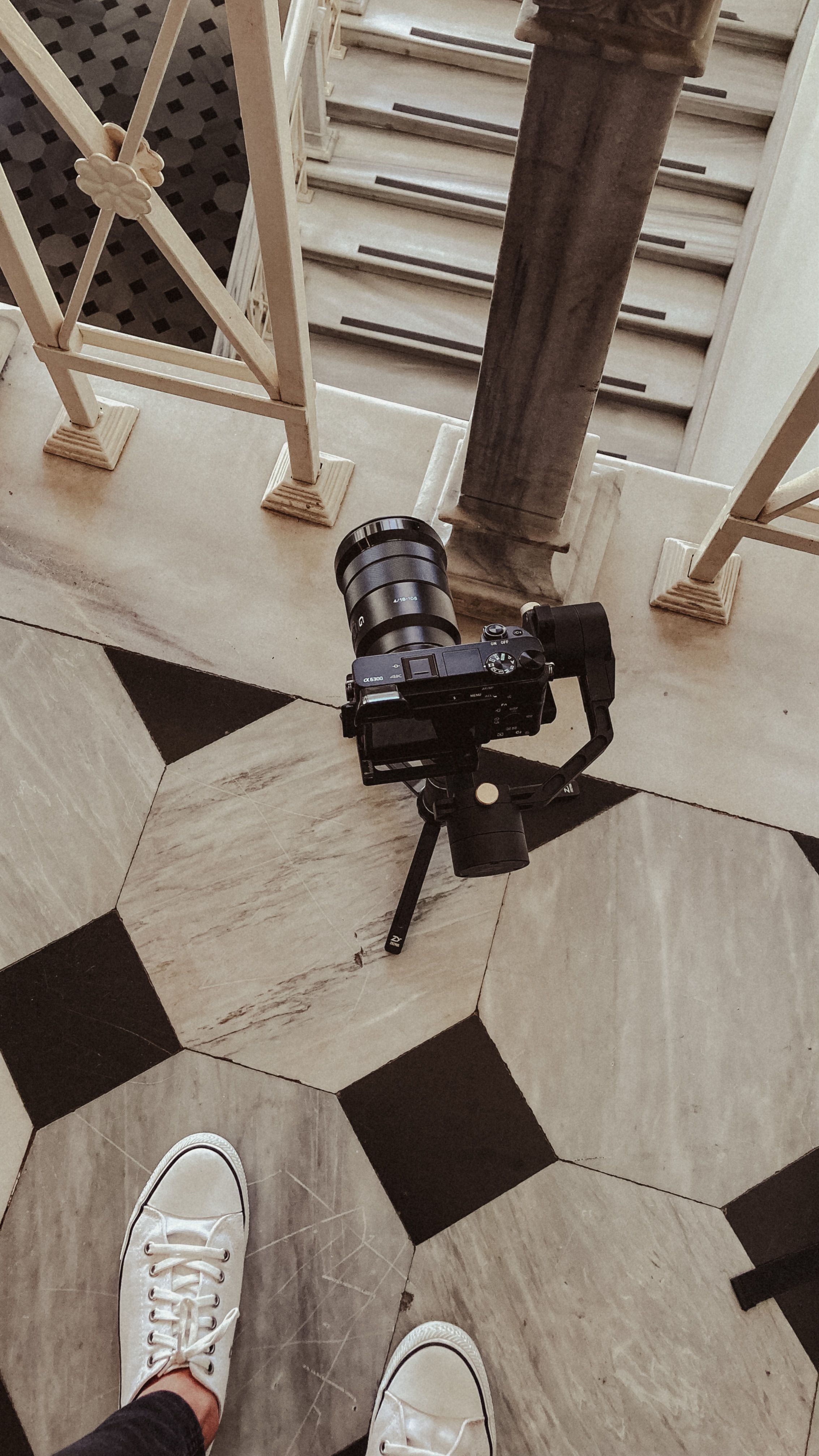 Stylish overhead perspective of a camera on a patterned floor, capturing urban aesthetics.