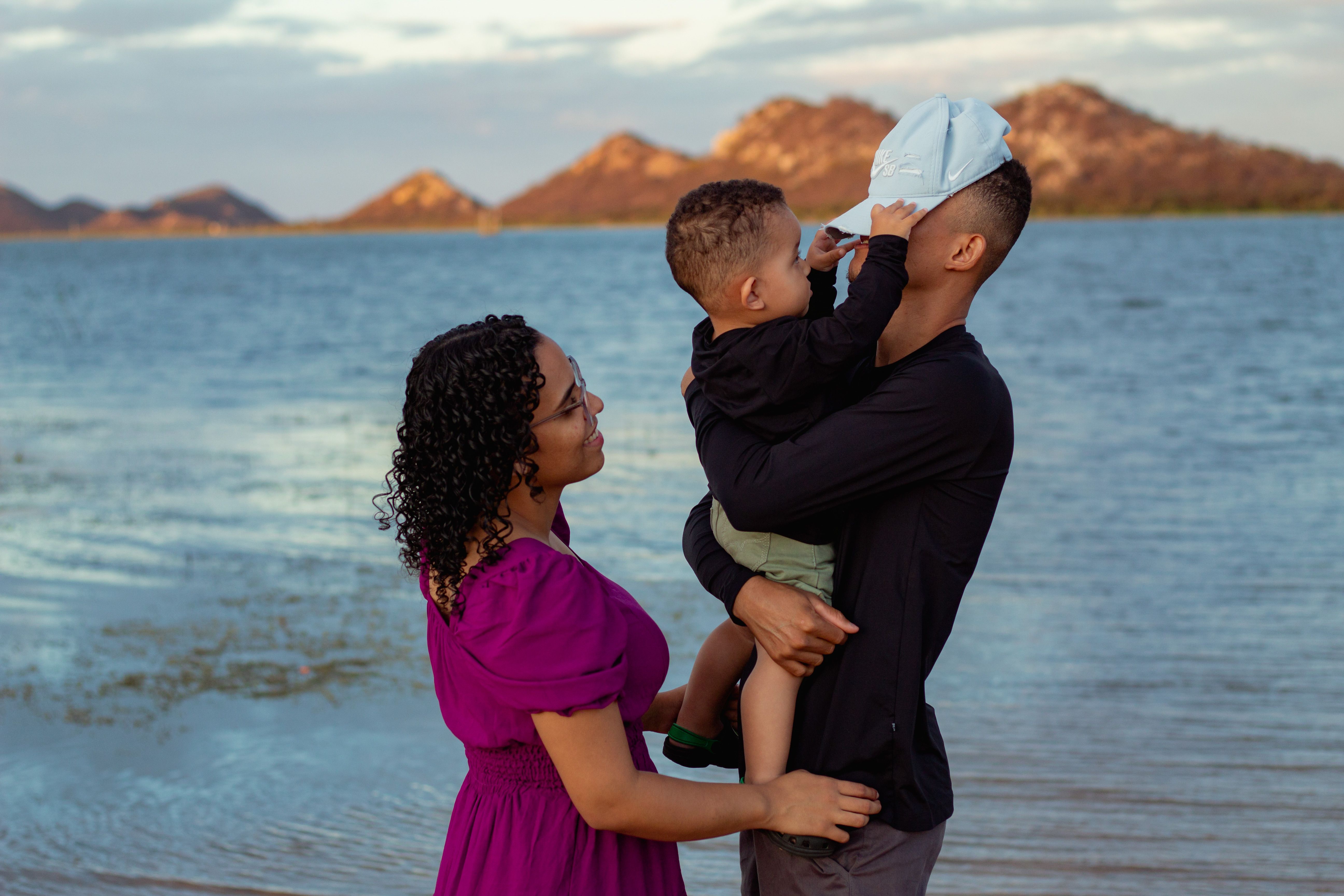 Photo of a Boy Holding His Father's Cap · Free Stock Photo