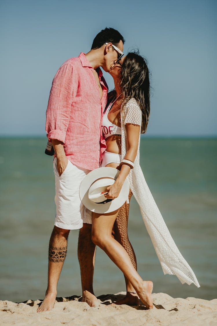 A Couple Kissing On A Beach