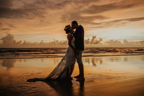 Photograph of a Couple Kissing at the Beach