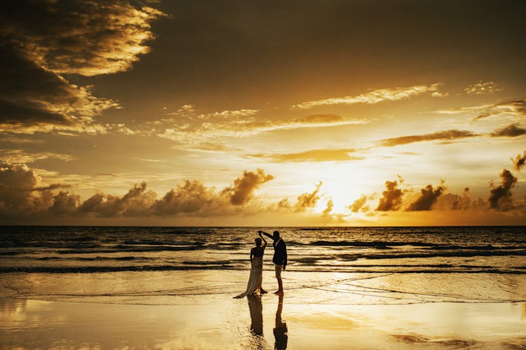 A Couple Dancing On The Beach