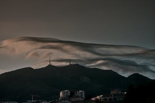 Silhouette of Mountain Under Dark Clouds