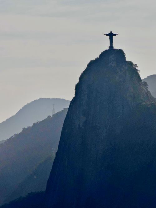 Free Iconic Christ the Redeemer statue atop Corcovado Mountain at dawn in Rio de Janeiro. Stock Photo