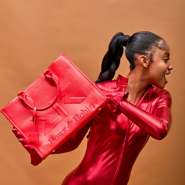 Woman In Red Outfit With Matching Bag