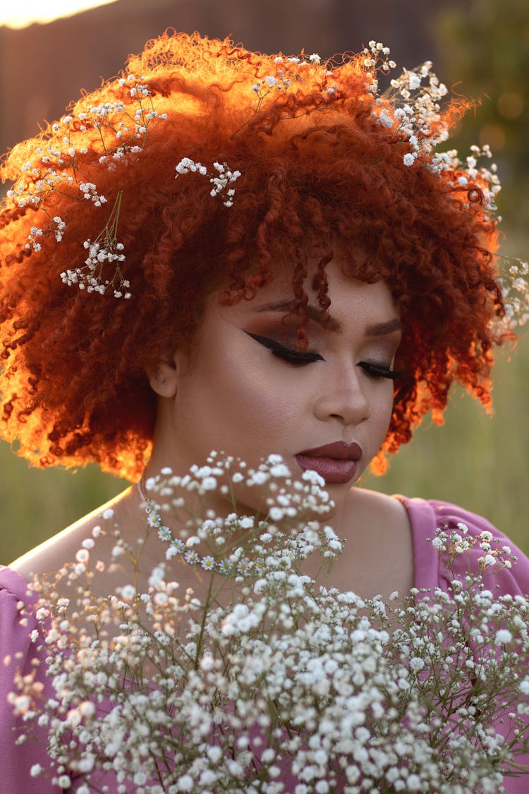 Portrait Of Woman With Red Afro Decorated With White Flowers