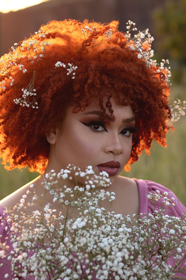 Portrait Of Woman With Red Afro Holding Bouquet Of White Flowers