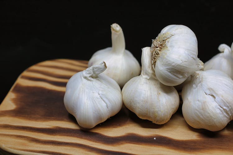 Garlic Bulbs On Brown Surface