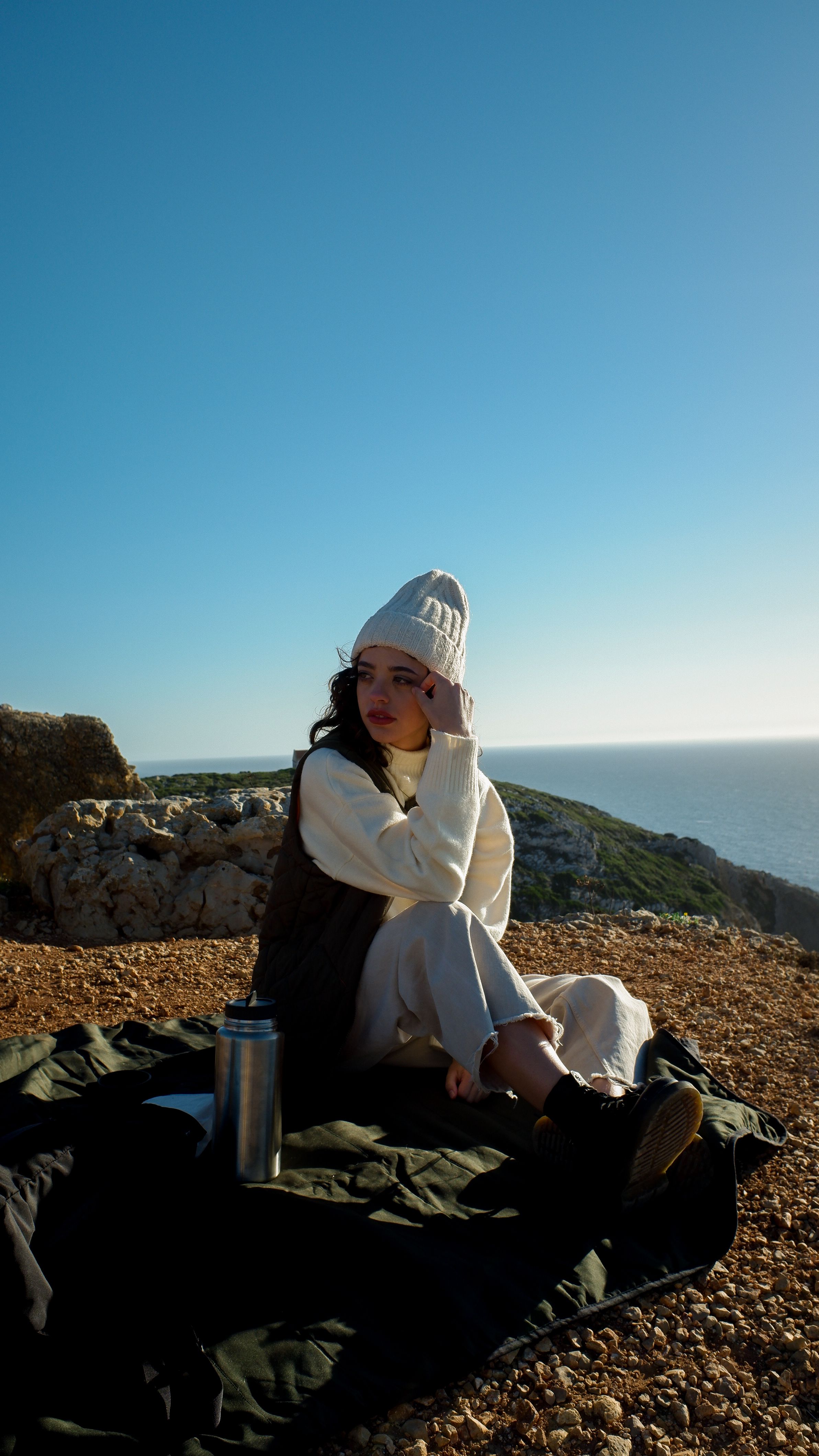 A Woman Sitting on a Cliff · Free Stock Photo
