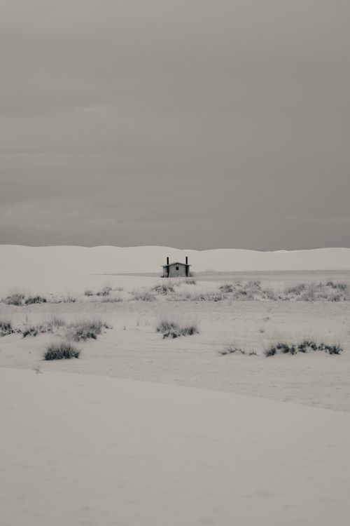Free Solitary cabin surrounded by snow on a vast winter landscape. Stock Photo