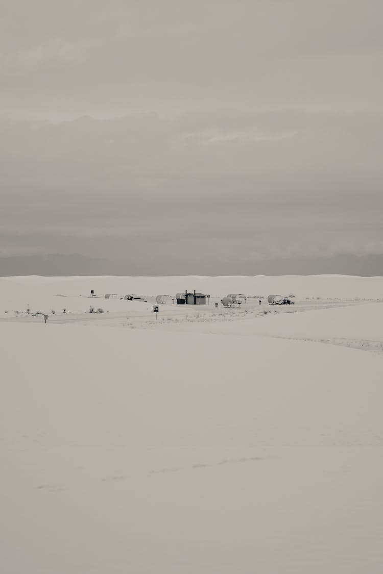 Snow Covered Ground Under Gray Sky