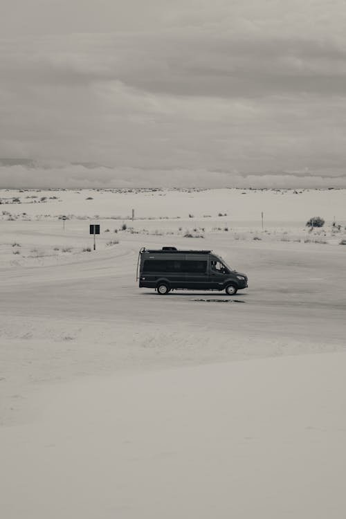 Black Van Travelling on a Snow Field