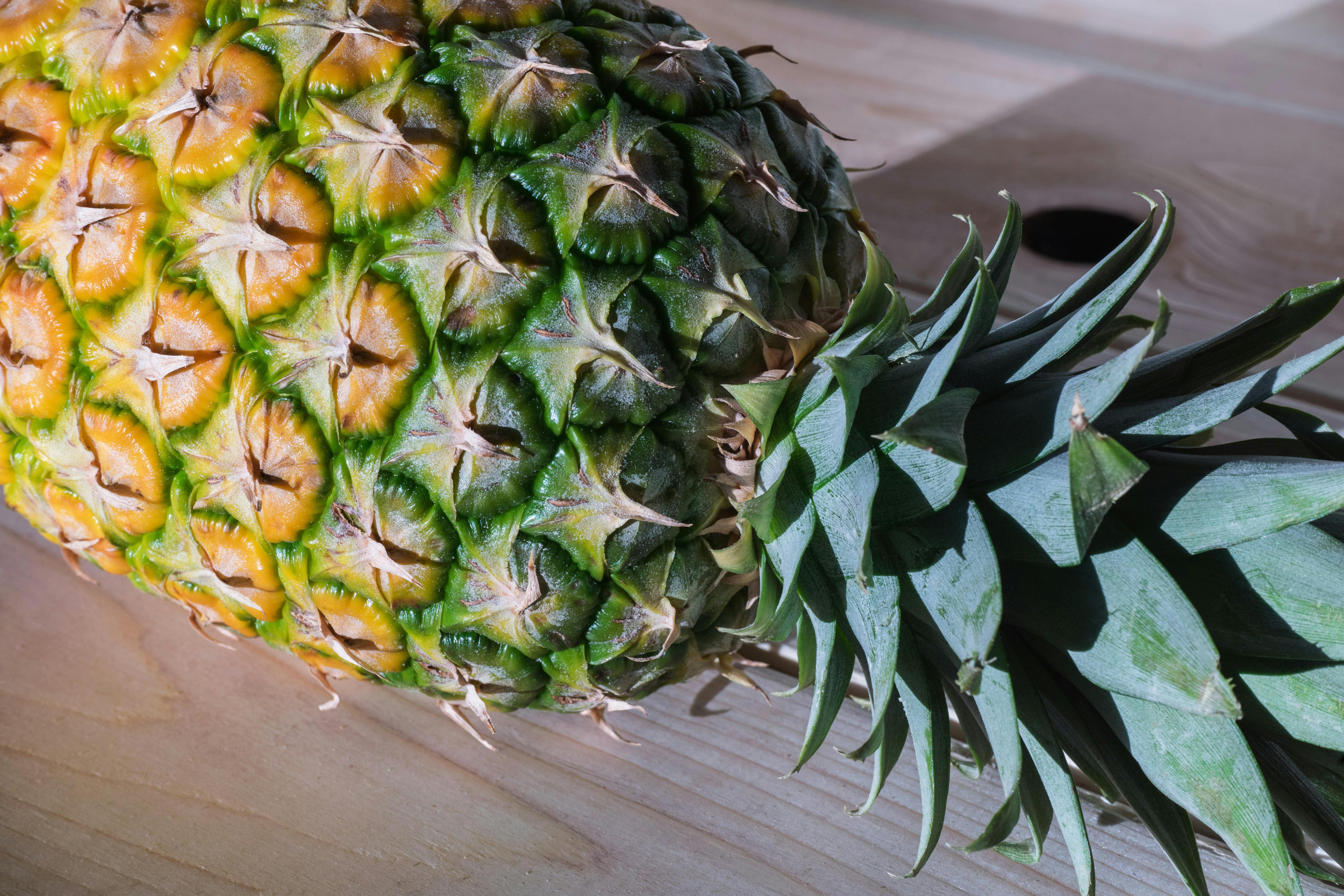 Pineapple on Brown Surface · Free Stock Photo