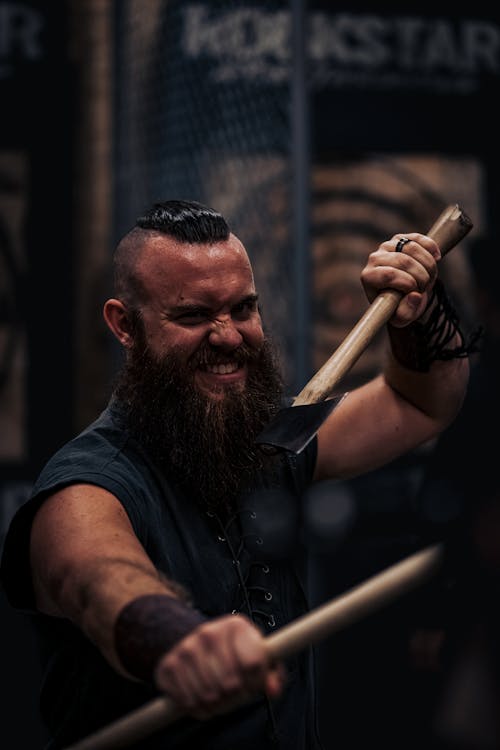 Man Looking like Dwarf with Axes