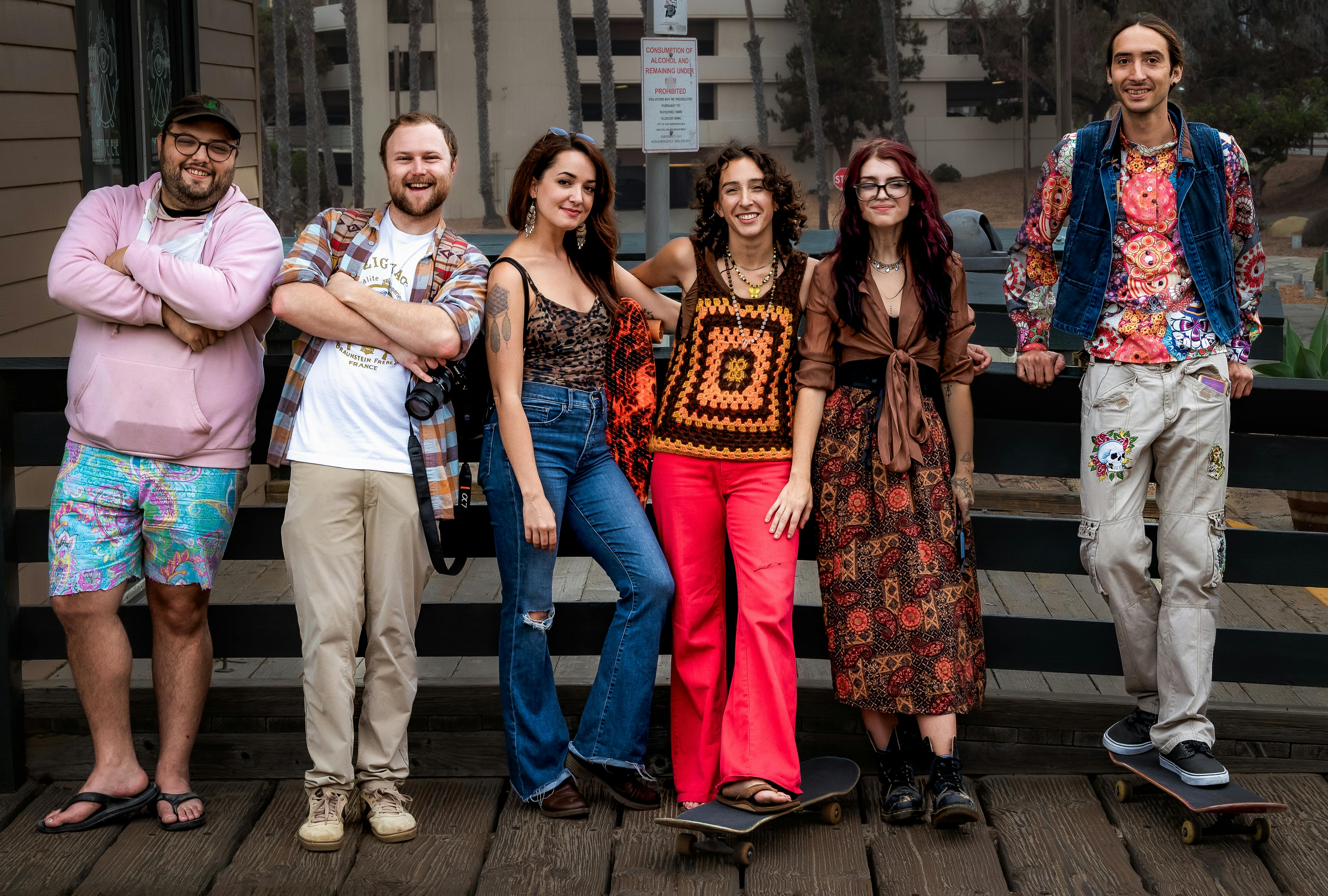 A diverse group of friends wearing retro and fashionable outfits outdoors, expressing urban lifestyle and individuality.