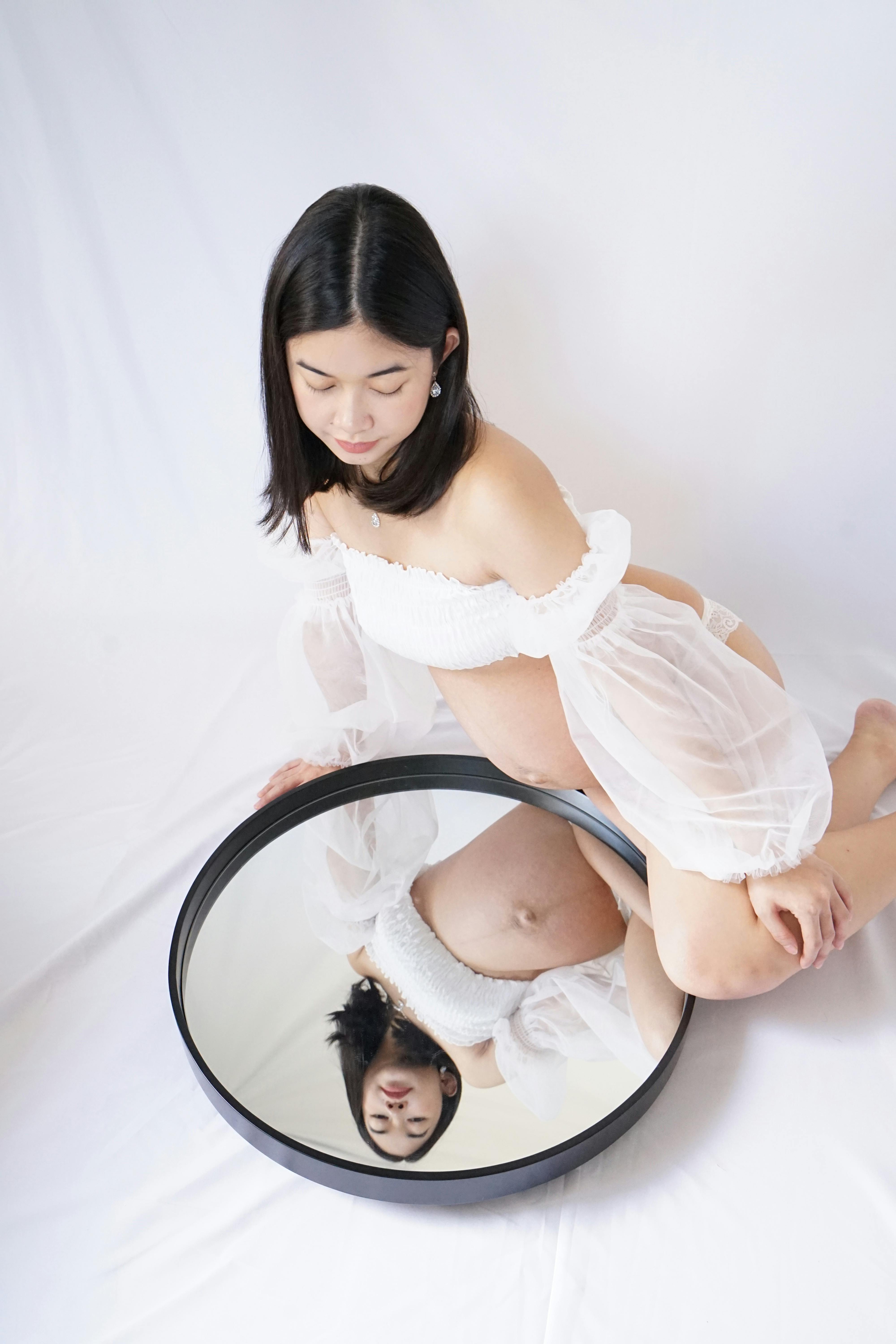 pregnant woman reflecting in mirror