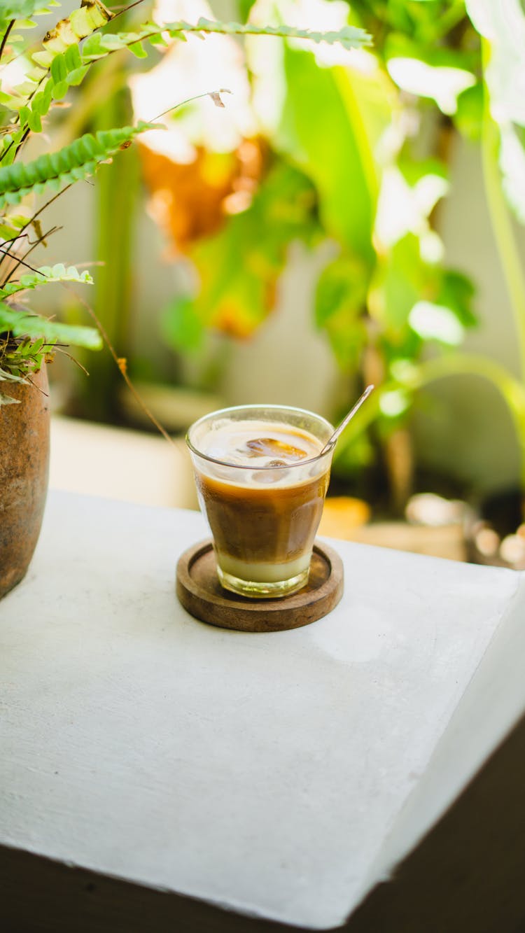 Glass Of Iced Coffee On Wooden Coaster