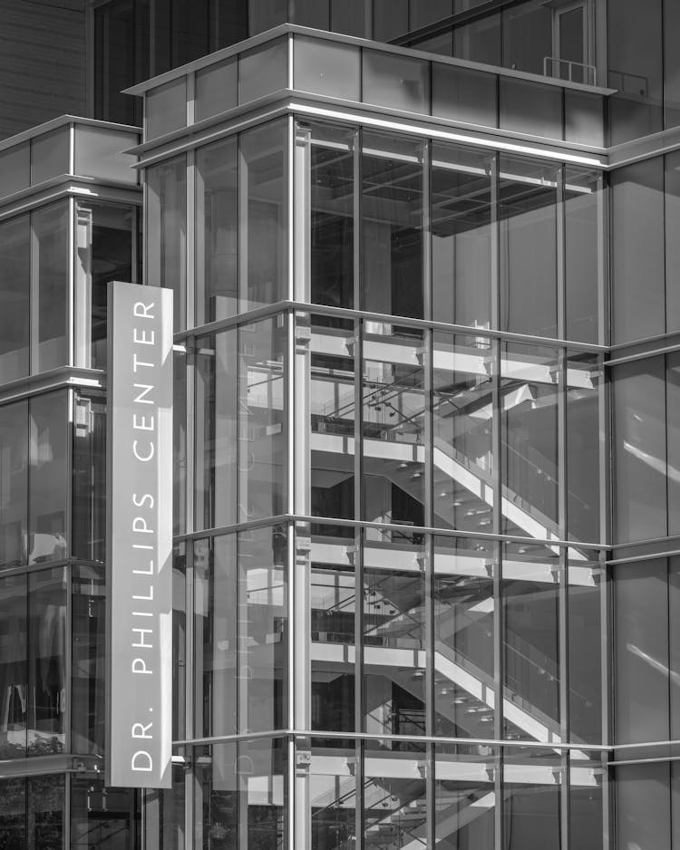 Modern Glass Building With Sign On Wall