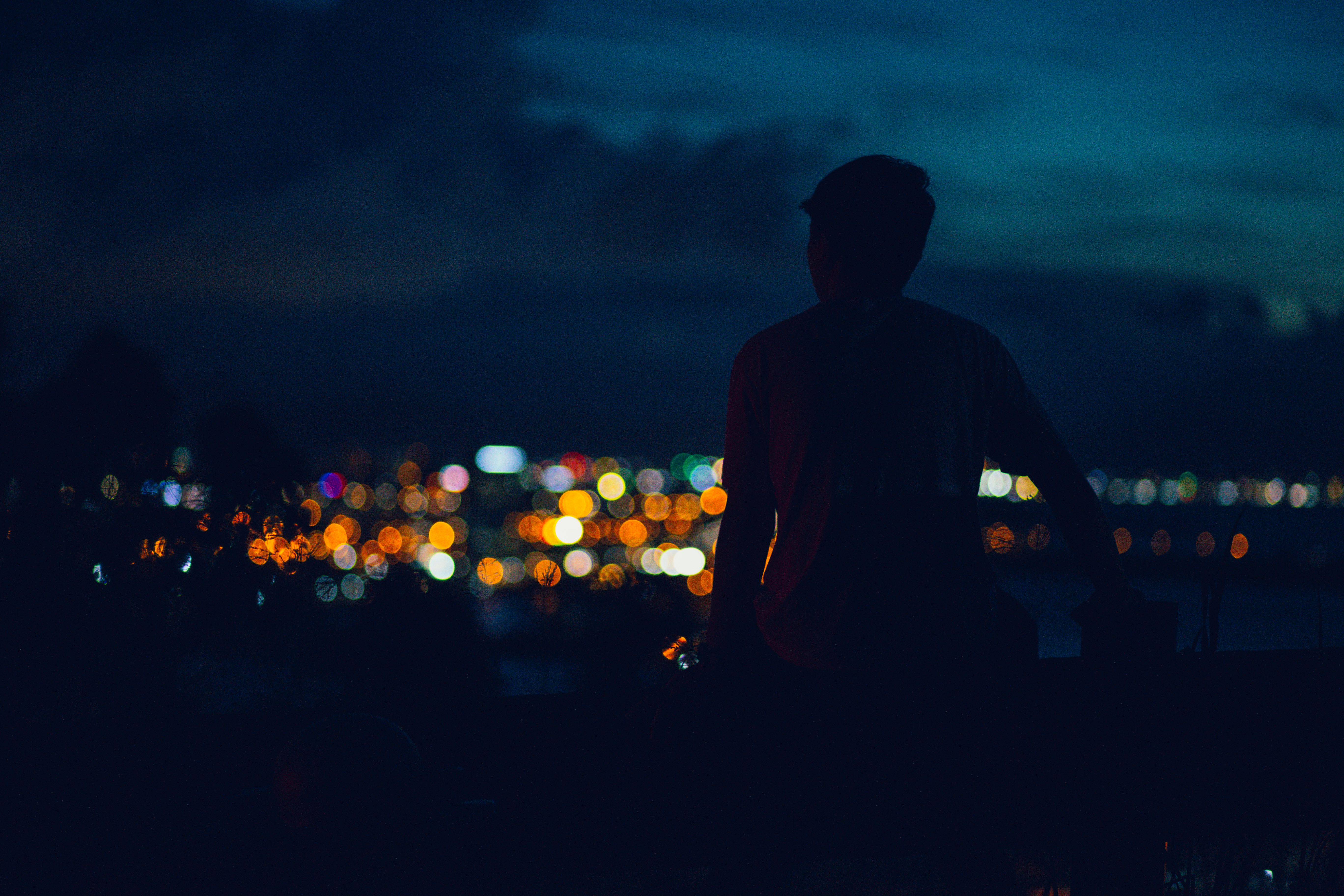 person standing alone city night