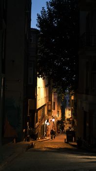 Explore a narrow, lamp-lit alley in Istanbul at night, capturing the city's historic charm.