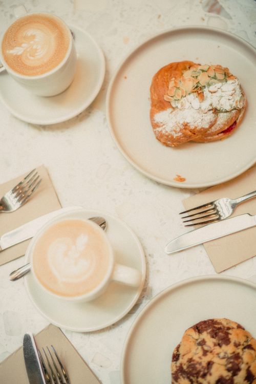 Free Top view of cappuccinos and pastries on a table, perfect for breakfast inspiration. Stock Photo