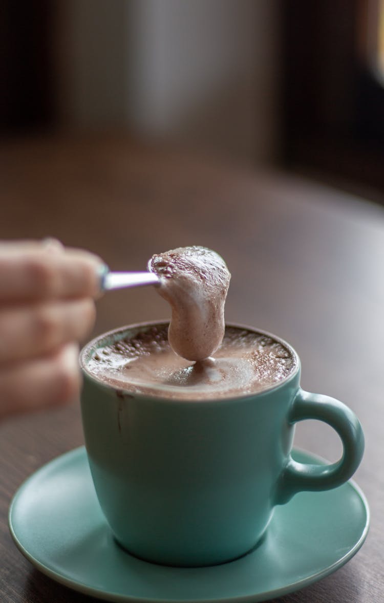 Coffee Foam Falling Off Spoon Into Cup