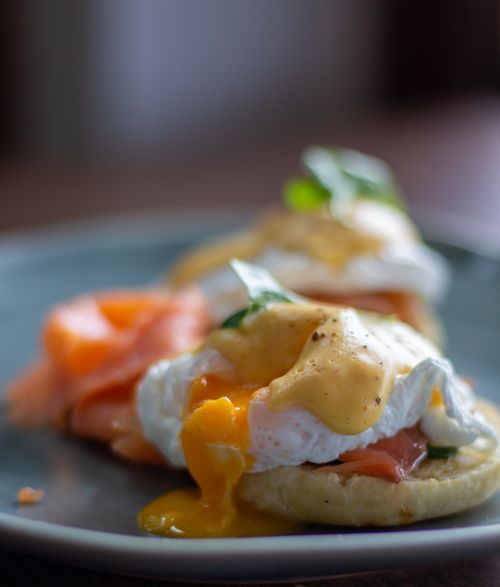 Free Close-up of eggs benedict with smoked salmon and hollandaise sauce on a plate. Stock Photo
