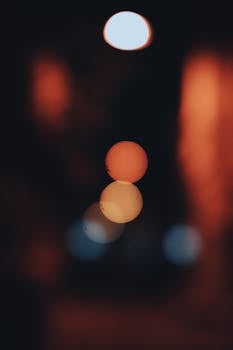 Artistic bokeh of city lights creates an abstract and moody atmosphere at night.