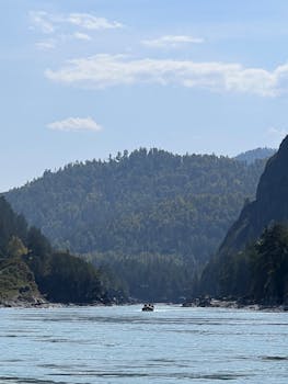 A peaceful river scene with mountains in the background, ideal for nature lovers.