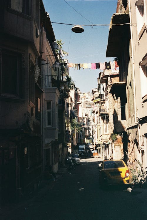 Laundry Hanging Above Narrow Alley 