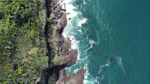 Aerial View of Rocky Mountain Beside Body of Water