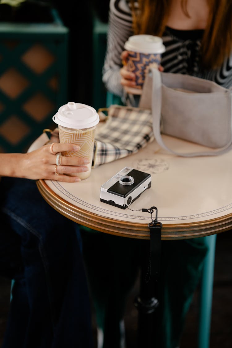 Women Sitting At A Table In A Cafe 