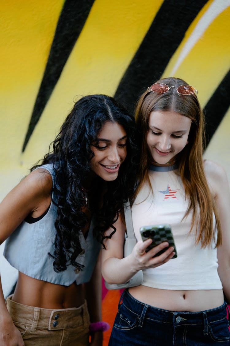 Women Looking At A Smart Phone Screen 