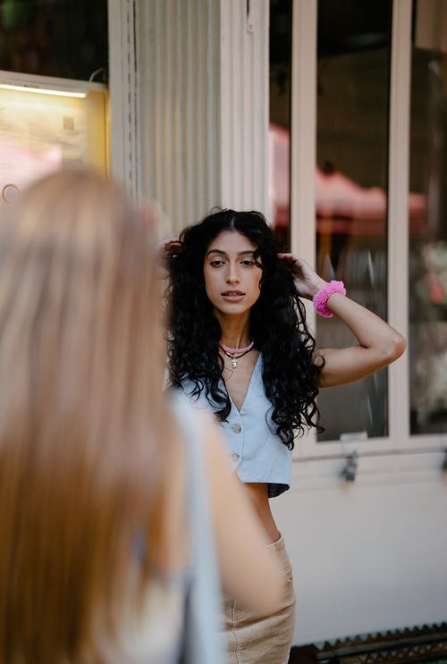 Free Two women posing on a city street during a sunny day, highlighting urban fashion and friendship. Stock Photo