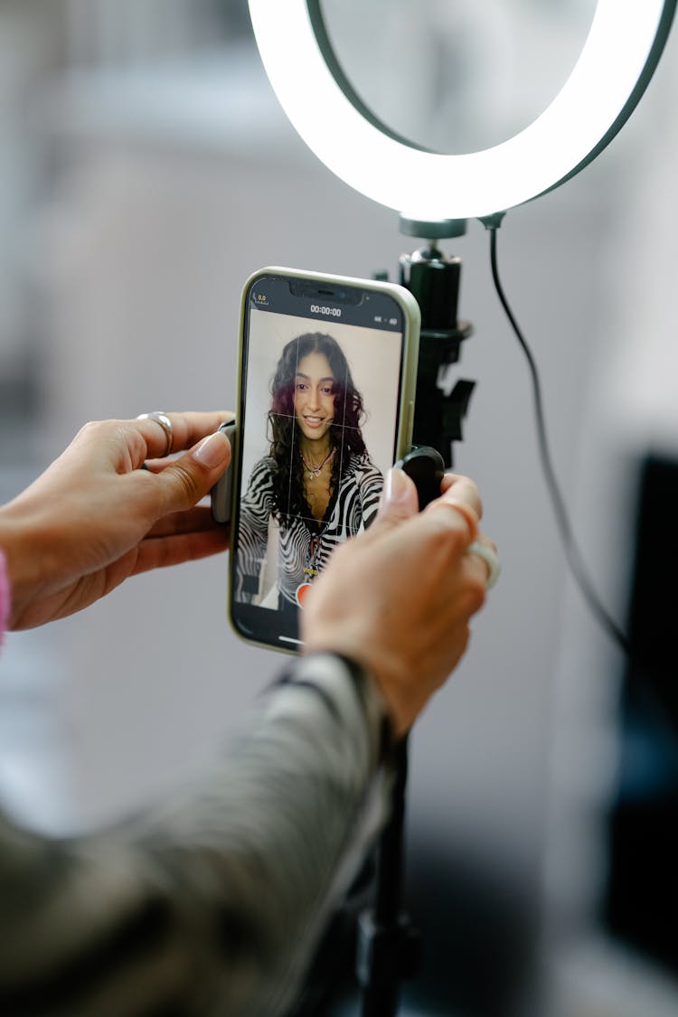 Woman Fixing A Smart Phone With A Portrait On The Screen 