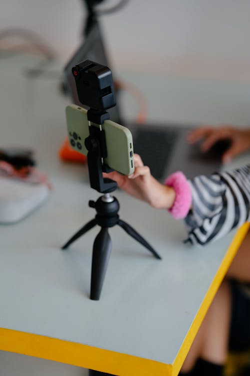 Woman Using a Smart Phone Fixed on a Tripod