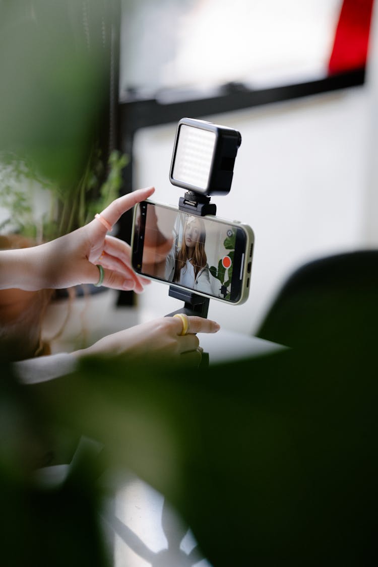 Woman Looking At A Photo On A Smart Phone Screen 