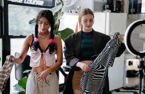 Free Two stylish women with unique outfits explore fashion choices indoors, embracing personal style. Stock Photo