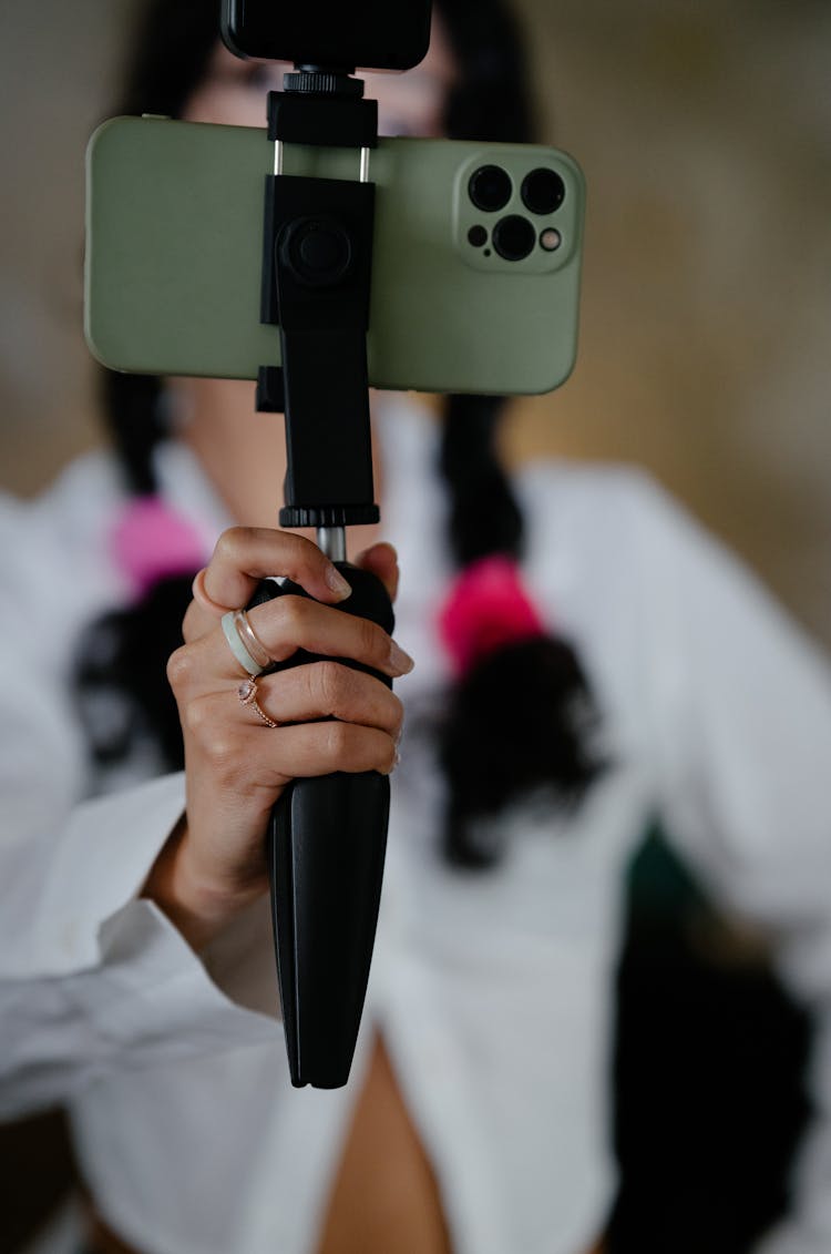 Woman Hand Holding Cellphone On Tripod