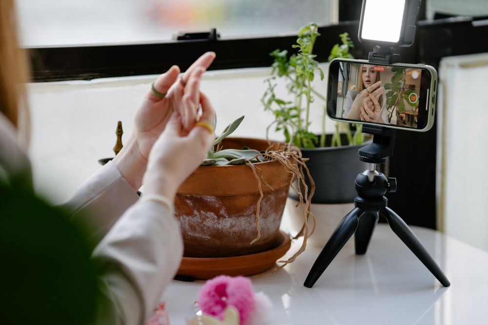 Phone on a tripod recording a video at home