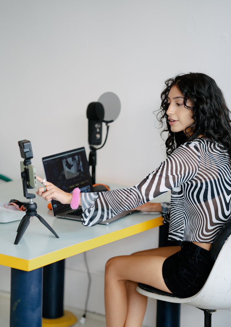 Woman Sitting At Desk With Equipment For Recording