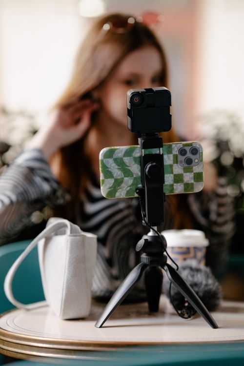 A picture of a person recording a video on their mobile phone