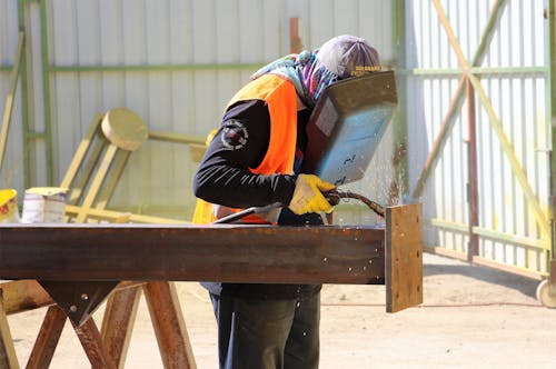 A Construction Worker Welding a Steel Bar