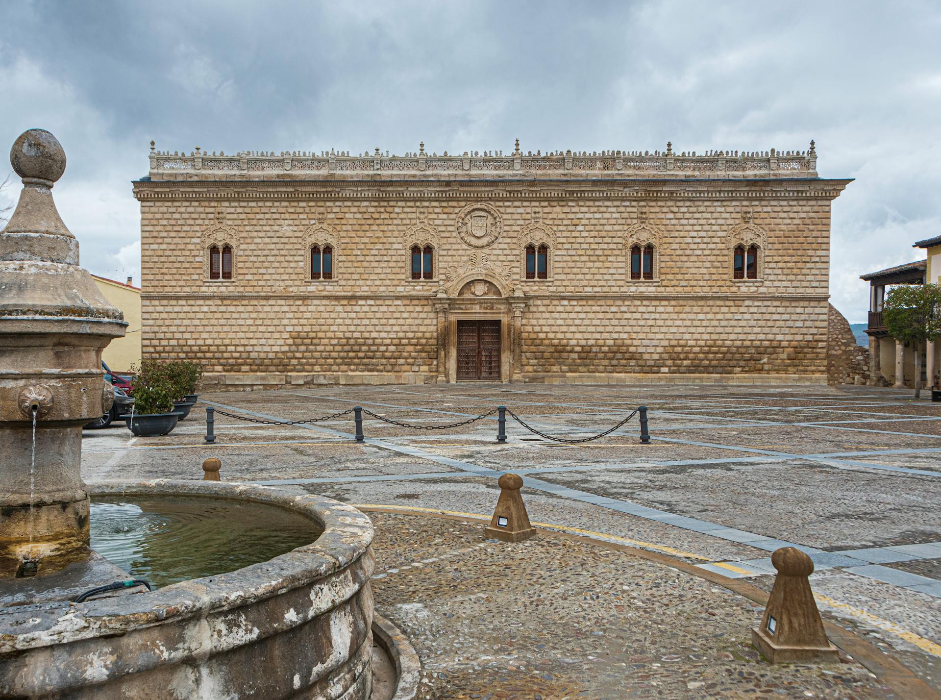 Renaissance palace in Cogolludo, highlighting its historic architecture with a classic stone facade and town square view.