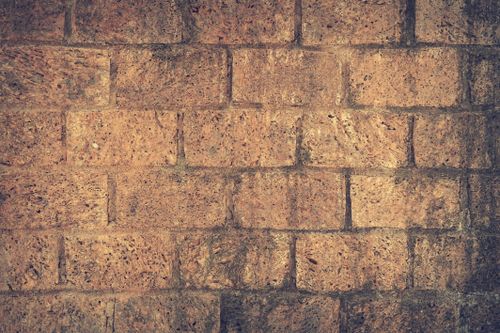 Free Close-up of a rugged brick wall showing texture and pattern for architectural backdrops. Stock Photo
