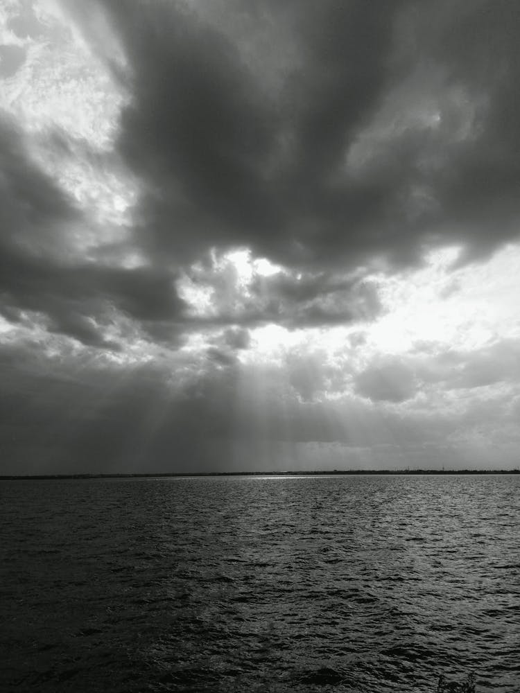 Grayscale Photo Of Dark Clouds Over Ocean