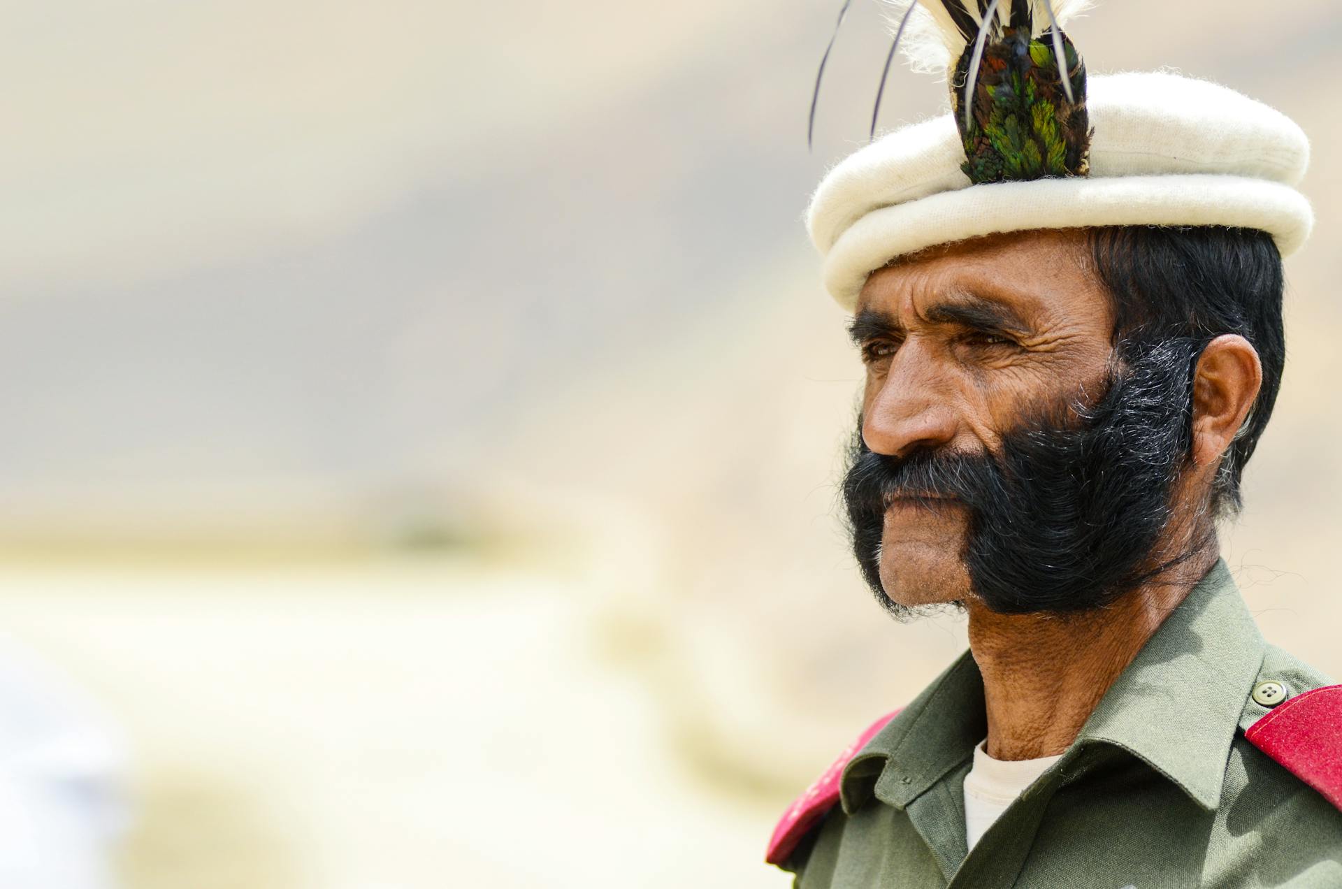 Close-Up Shot of a Bearded Elderly Man in Military Uniform