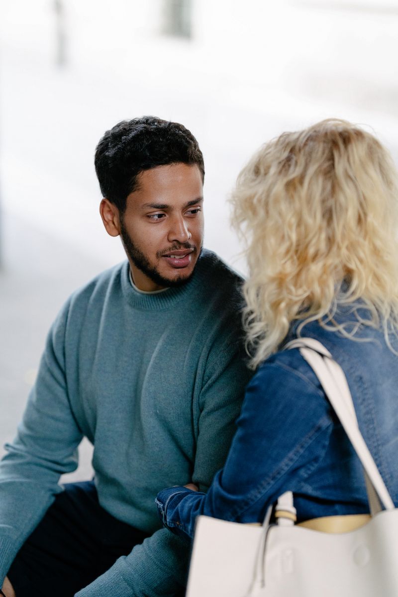 Couple sitting outdoors and talking openly; illustrative stock photograph